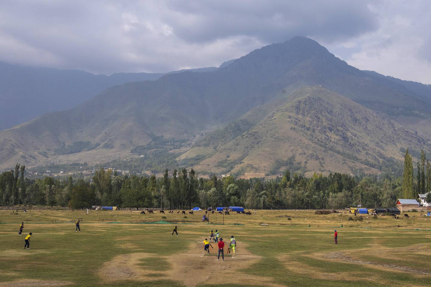 Kashmiri men play cricket on the outskirts of Srinagar. AP Photo