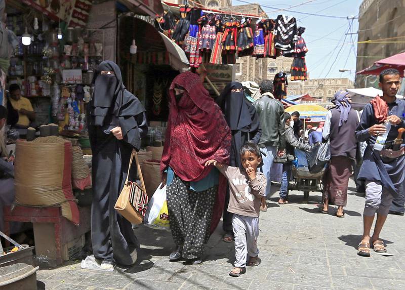 Yemeni women walk past shops in the old city market of the capital Sanaa, on March 2, 2020. - In recent months, a series of incidents in the rebel-held north illustrates the Huthis' determination to impose their own moral order on Yemenis who have already endured five years of grinding conflict: restaurants where men and women mingle have been shut down, scissor-wielding militia have policed men's hairstyles, and rebel forces have patrolled college campuses to enforce dress codes. (Photo by MOHAMMED HUWAIS / AFP)