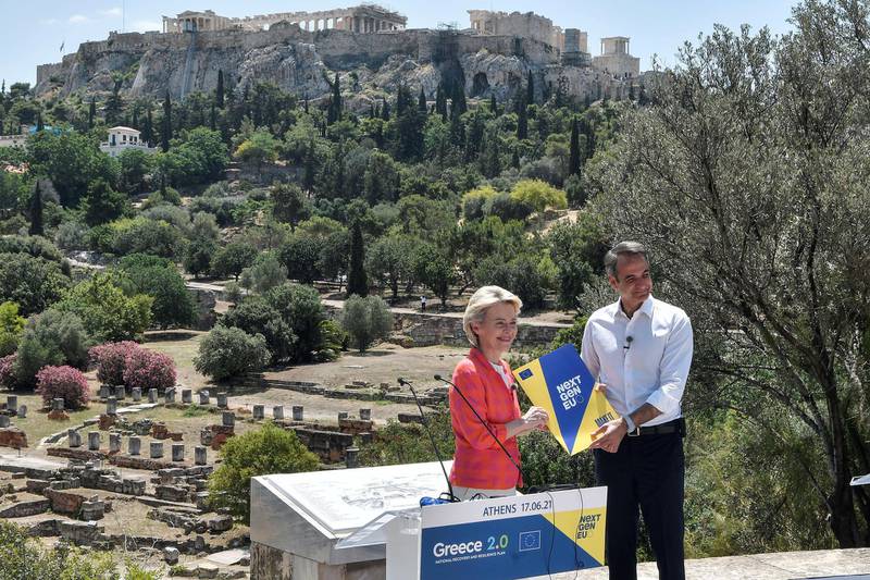 Greek Prime Minister Kyriakos Mitsotakis and European Commission President Ursula von der Leyen hold a dossier during an event at the Ancient Agora in Athens, Greece, June 16, 2021. Louisa Gouliamaki/Pool via REUTERS