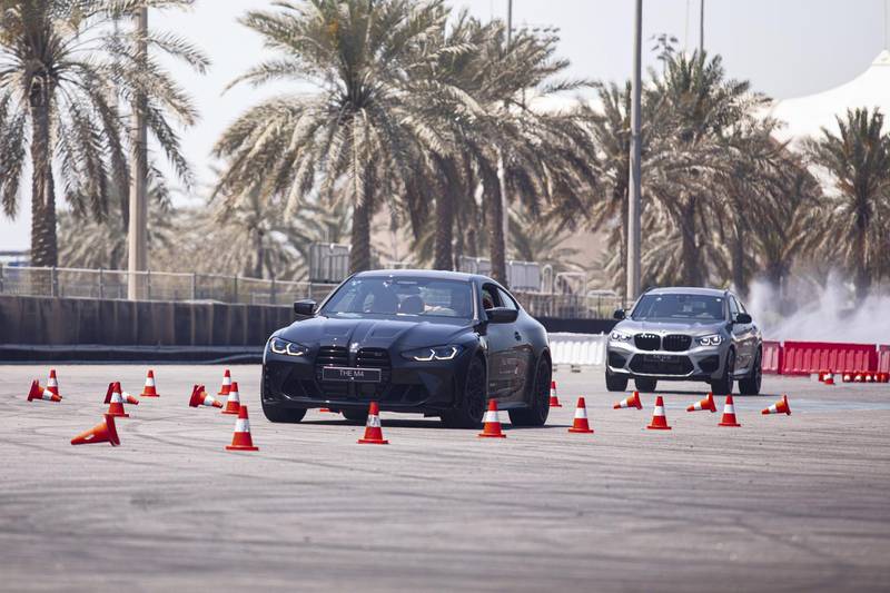 An M4 driver takes on a slalom course.