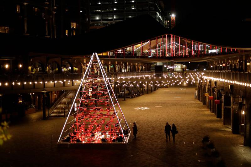 People walk past the 'Terrarium Tree' in Coal Drops Yard, which forms part of the King's Cross neighbourhood of London's unconventional 'traditionally untraditional' Christmas tree installations. AP Photo