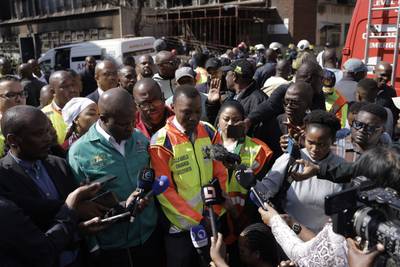 Johannesburg mayor Kabelo Gwamanda talks to the media at the scene of the fire. AFP