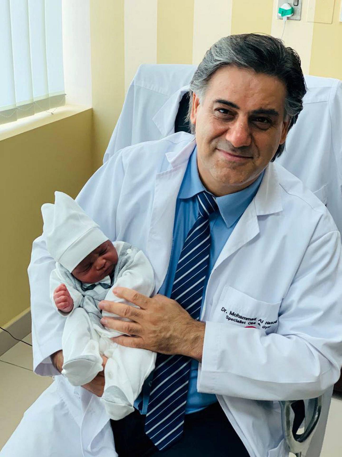 Doctor Muhammad al Hassoun, specialist in obstetrics and gynecology and infertility holding baby Maher born to Somalian couple who finally had a boy after 20 years of trying to conceive. 