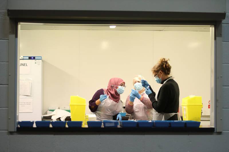 Pharmacy staff members prepare vaccines at STEAM Museum in Swindon. Reuters