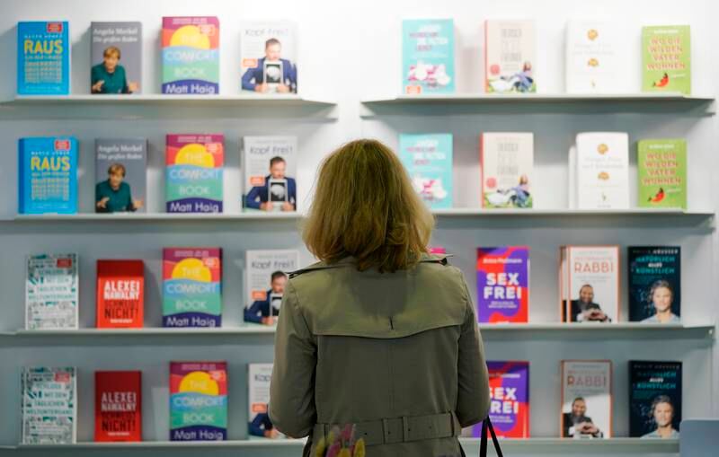 Visitors browse books at the international book fair Frankfurter Buchmesse 2021. The 73rd Frankfurt Book Fair runs until October 24. EPA