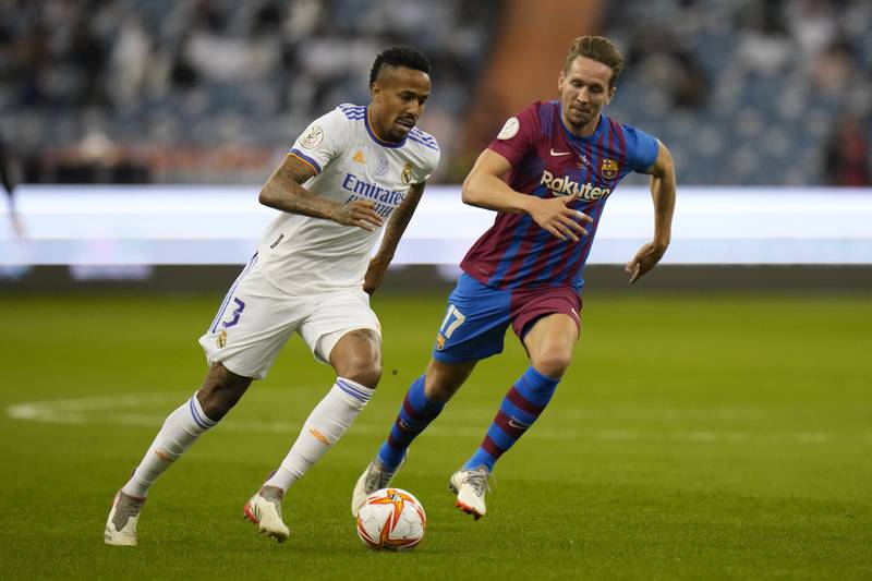 Real Madrid's Eder Militao in action with Barcelona's Luuk de Jong. AP Photo