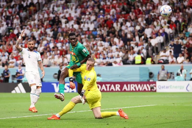 Ismaila Sarr of Senegal shoots past Jordan Pickford of England. Getty