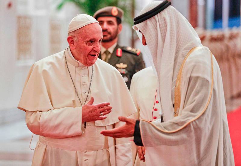 Pope Francis is welcomed by Sheikh Mohamed. AFP