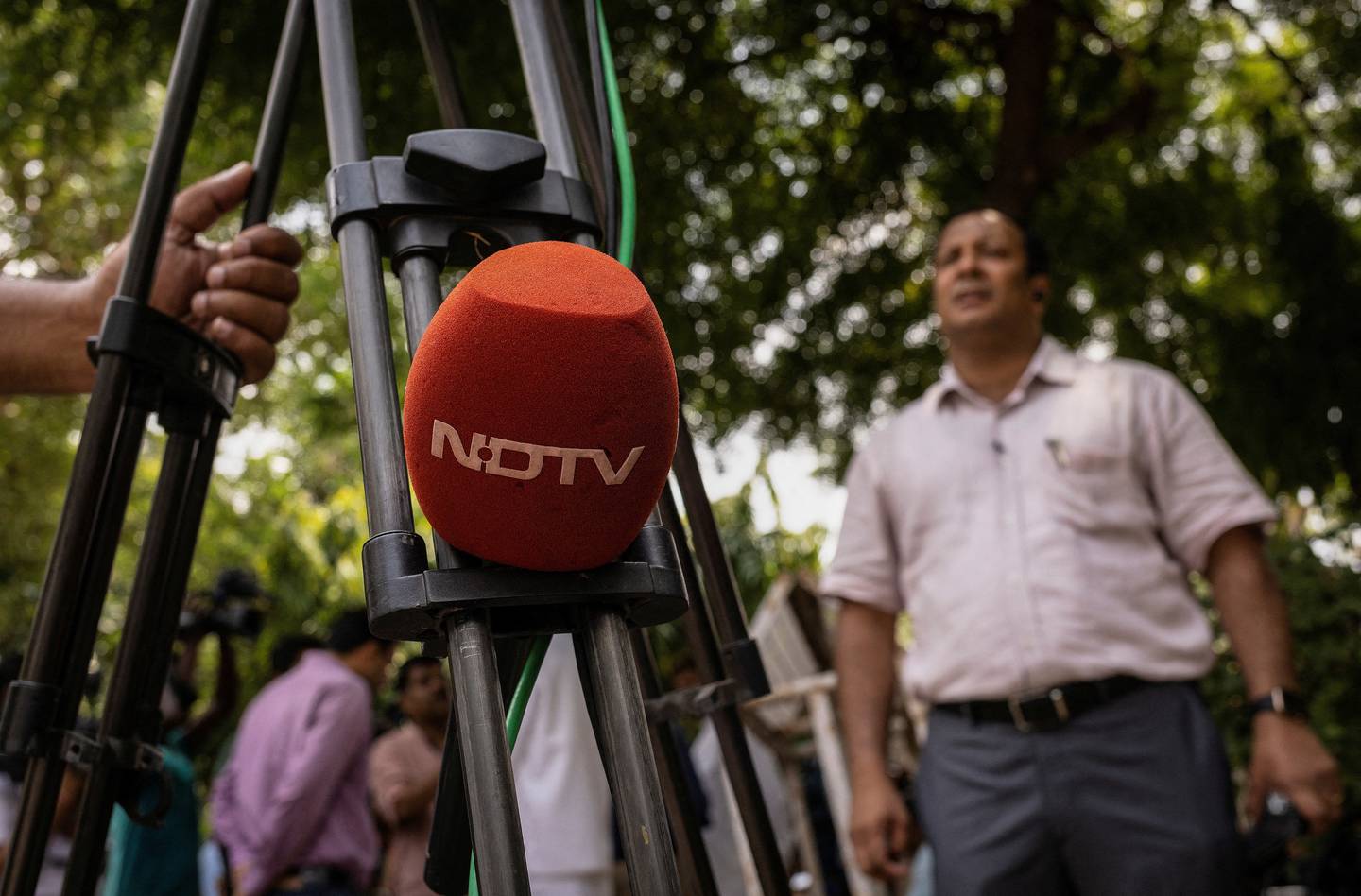 A microphone of New Delhi Television is placed on a tripod along a roadside in New Delhi.  Reuters
