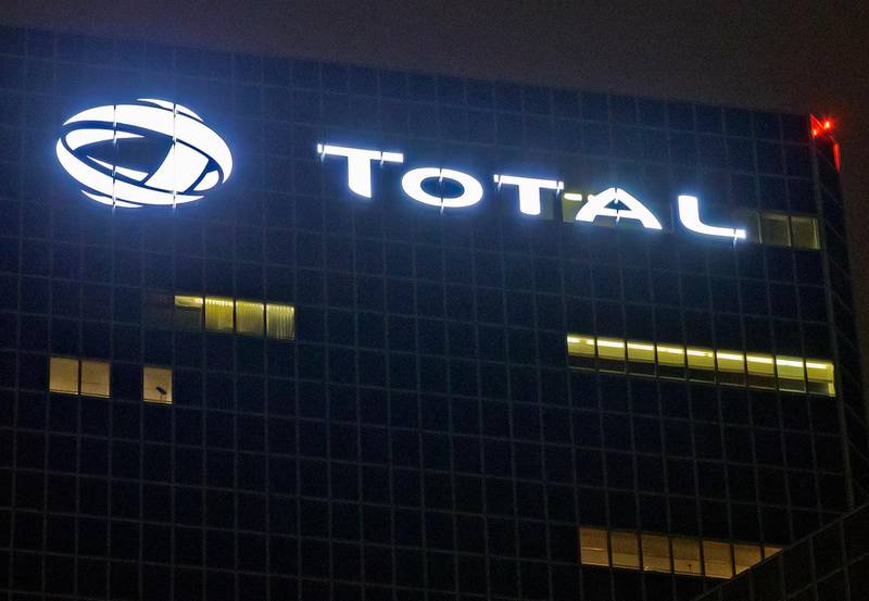 FILE - In this file photo taken on Oct.12, 2016, the logo of French oil giant Total SA is pictured at company headquarters in La Defense business district, outside Paris. French oil and gas company Total says it will not continue a multi-billion dollars project in Iran unless it is granted a waiver by U.S. authorities. (AP Photo/Michel Euler, File)