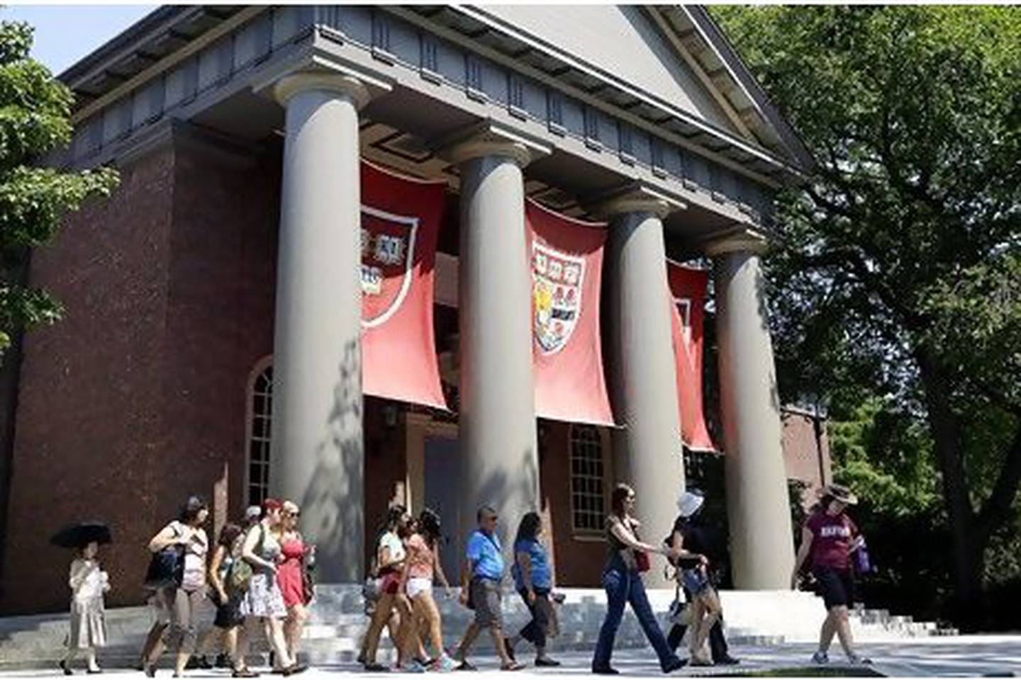 Flags hang in Harvard Yard bearing the university's slogan, Veritas, which is the Latin word for "truth". Sipa Press / Rex Features