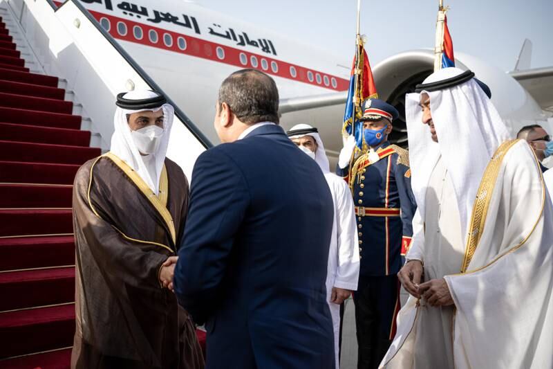 Sheikh Mansour is welcomed by Mr El Sisi as Sheikh Mohamed watches on. Rashed Al Mansoori / Ministry of Presidential Affairs
