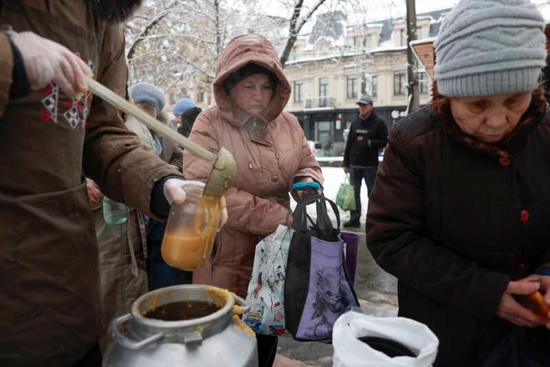 People in need receive food and gloves from a charity in Kyiv. Getty Images