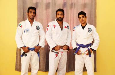 ABU DHABI, UNITED ARAB EMIRATES , April 22– 2020 :- Khaled Al Awlaqi, former Jiu Jitsu player (center) with his sons Mahdi Al Awlaqi (17 left) and Faraj Al Awlaqi (15 right) both blue belts, and in the UAE high performance squad at their home in Baniyas area in Abu Dhabi.  (Pawan Singh / The National) For Sports/Online. Story by Amith