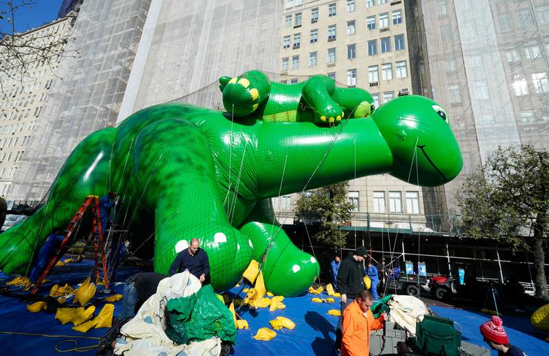 Members of the Macy's Inflation Team work to inflate the Dino and Baby Dino balloon. AFP
