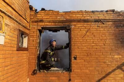 A firefighter works at a residential district that was damaged by shelling, as Russia's invasion of Ukraine continues, in Kyiv, Ukraine. Reuters