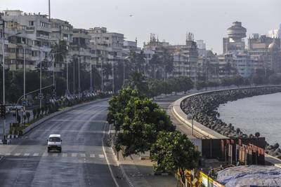 A vehicle travels on an empty street in the Marine Drive area during a lockdown imposed due to the coronavirus in Mumbai, India, on Sunday, April 5, 2020. The World Bank has offered $1 billion in emergency financing to help India increase its screening, contact tracing, and laboratory diagnostics to fight the coronavirus outbreak. Photographer: Dhiraj Singh/Bloomberg