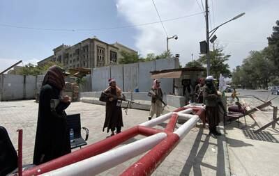 Taliban fighters stand guard outside the Green Zone where most of the embassies are situated.