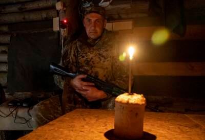 A Ukrainian Territorial Defence fighter in a shelter with an Easter Cake near Kharkiv. Ukrainians mark Orthodox Easter today. EPA
