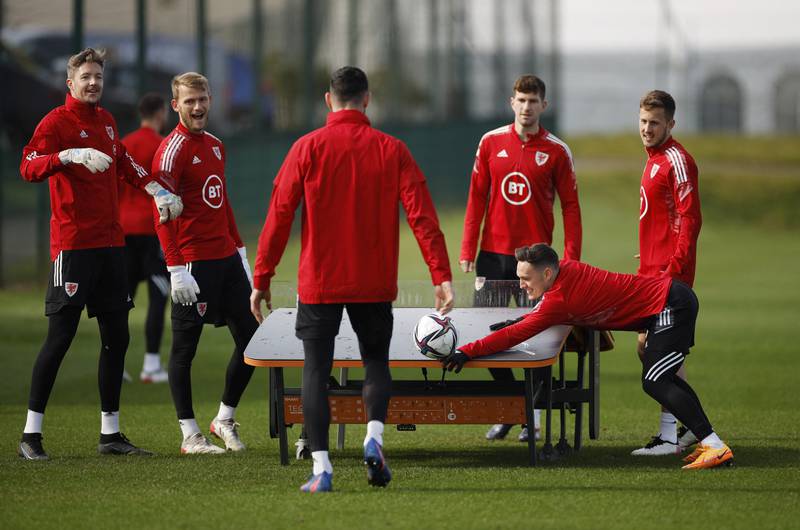 Wales' Connor Roberts and teammates around the Teqball table during training. Reuters