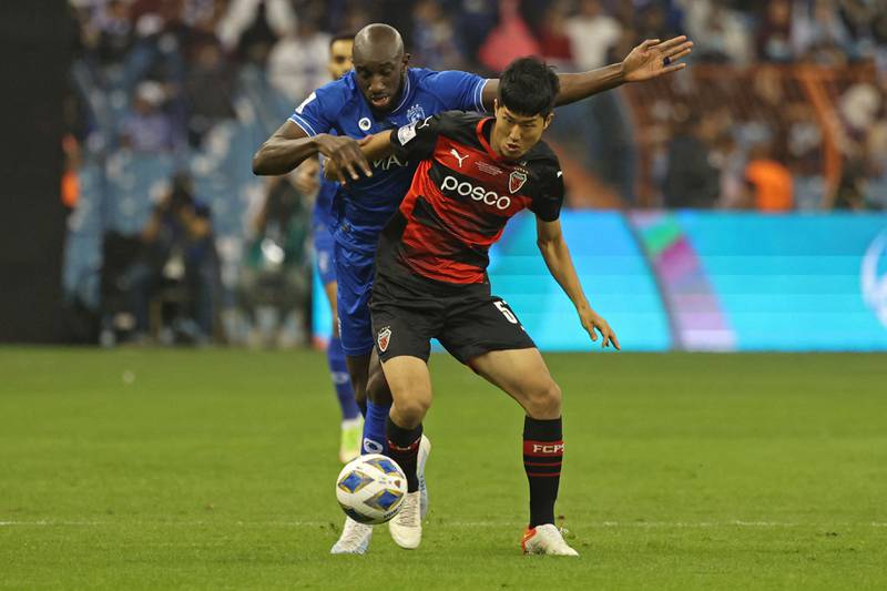 Pohang midfielder Lee Soo-bin and Hilal attacker Moussa Maregabattle for possession. AFP