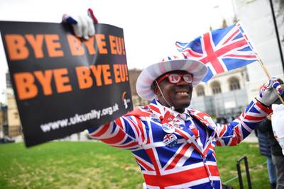 LONDON, ENGLAND - JANUARY 31: A man poses in a Union Jack suit at Parliament Square as people prepare for Brexit on January 31, 2020 in London, United Kingdom. At 11.00pm on Friday 31st January the UK and Northern Ireland will exit the European Union 188 weeks after the referendum on June 23rd 2016.  (Photo by Jeff J Mitchell/Getty Images)