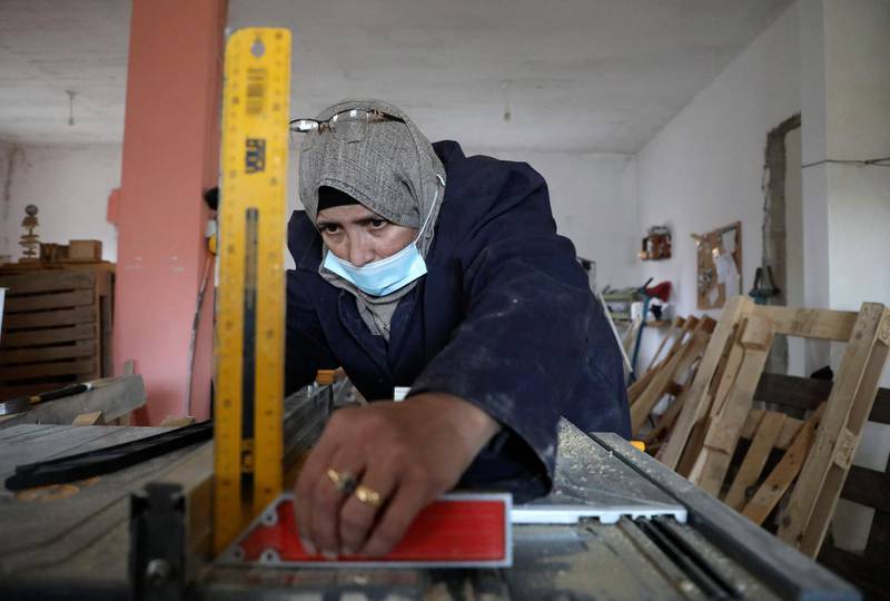 A Palestinian woman works at a carpenter workshop, established and run by a group of women, in the village of Al Walajeh near the West bank town of Bethlehem. AFP