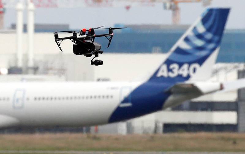 A drone flies near an Airbus A340 aircraft in Colomiers near Toulouse, France, October 19, 2017. REUTERS/Regis Duvignau