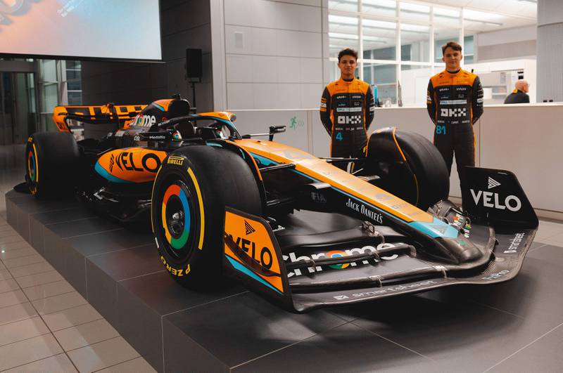 McLaren drivers Lando Norris, left, and Oscar Piastri with the MCL60 car for the 2023 season in Woking. AFP