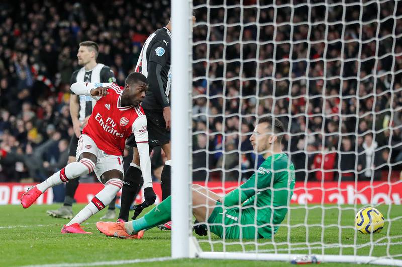 Arsenal's Nicolas Pepe, left, after scoring his side's second goal. AP
