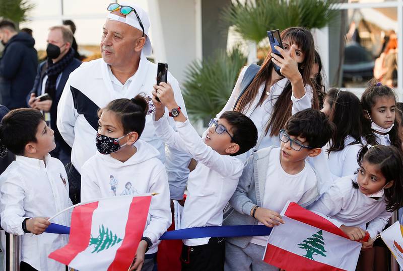 Children holding Lebanese flags wait for Pope Francis at Larnaca International Airport. Reuters