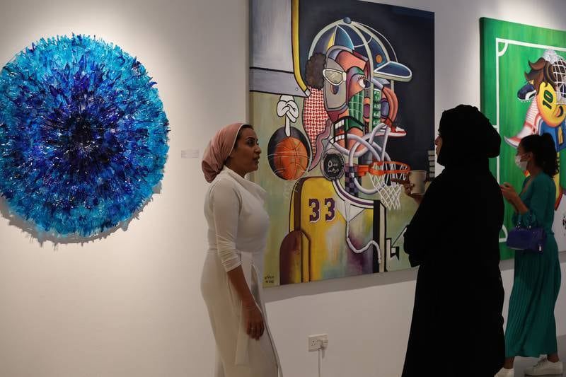 Badr Abbas, also a member of Tashkeel, mishmashes local pop culture references in his acrylic paintings, which feature jerseys of local football teams layered against dirham coins and ghutra fabric in Cubist arrangements.