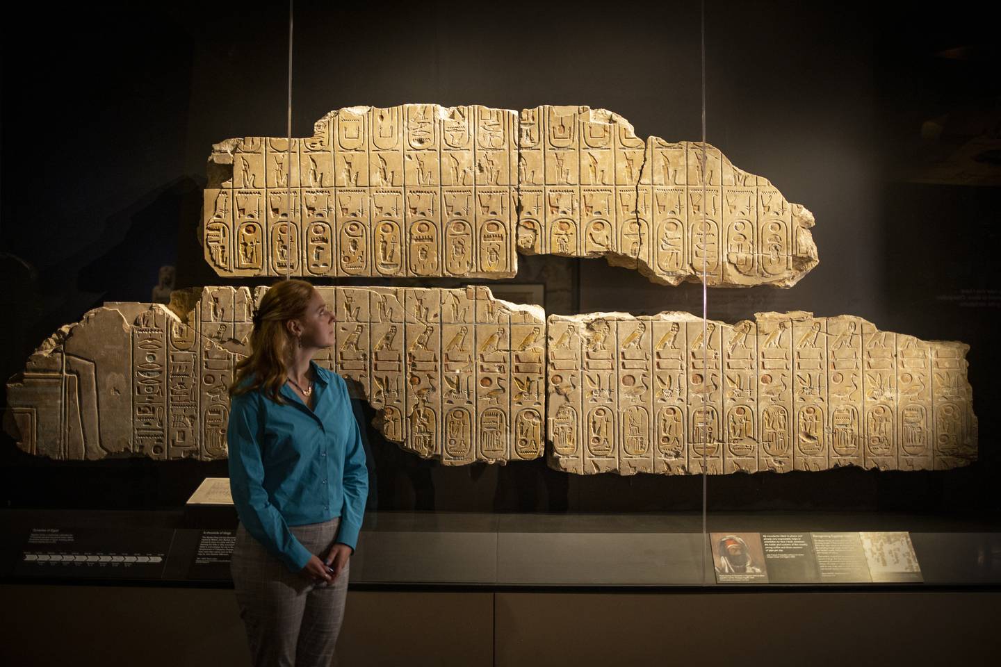 A British Museum member of staff poses next to the Rosetta Stone during a photocall for the coming Hieroglyphs: unlocking ancient Egypt exhibition in London on Thursday. EPA