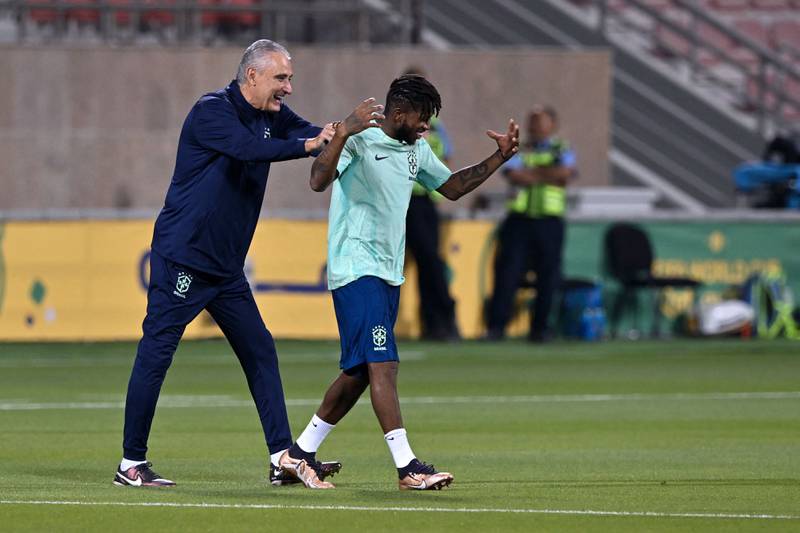 Brazil's coach Tite and midfielder Fred during training. AFP