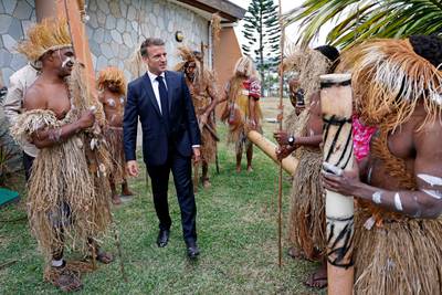 French President Emmanuel Macron attends a welcome ceremony with traditional dancers and warriors at the local Senate in Noumea last month. AFP