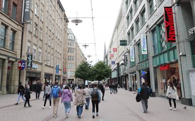 epa08438847 Shoppers walk on the Spitaler Strasse shopping street in Hamburg, northern Germany, 23 May 2020. Most shops in Germany are open again after a lockdown due to the SARS-CoV-2 coronavirus outbreak which causes the COVID-19 disease.  EPA/FOCKE STRANGMANN