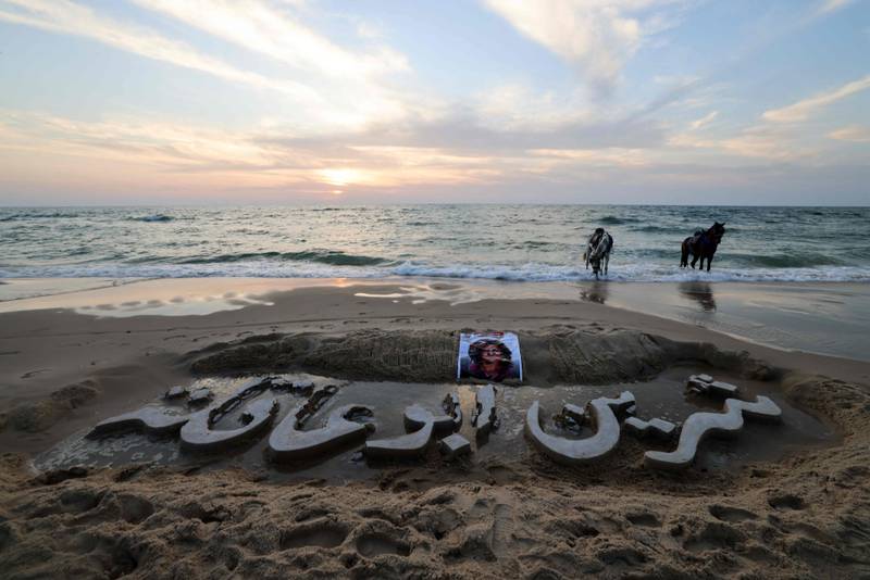 The name of slain Palestinian journalist Shireen Abu Akleh is carved in the sand on a beach in Gaza city. AFP