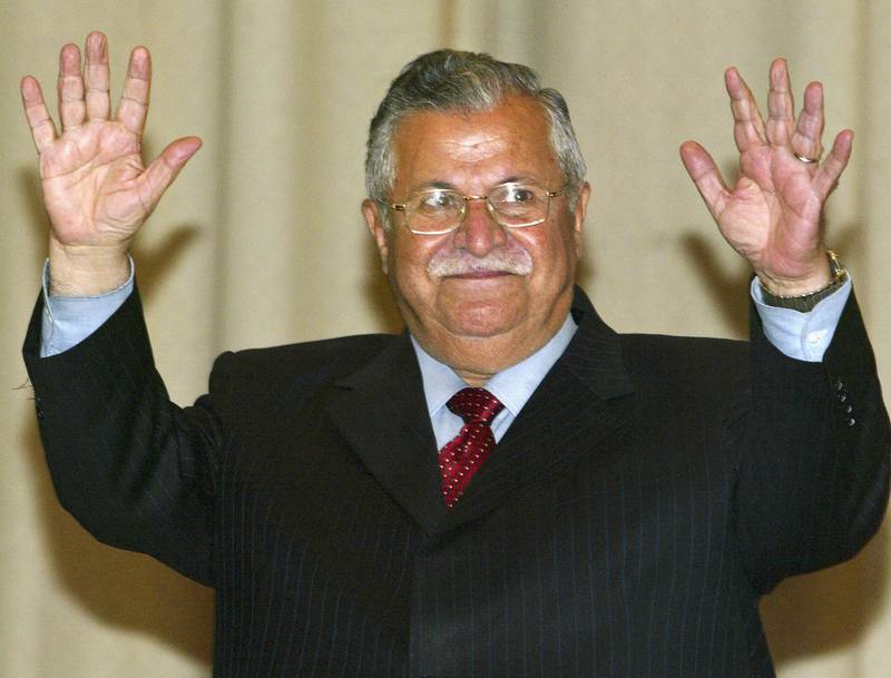 April 7, 2005: Veteran Kurdish leader Jalal Talabani raises his hands after being sworn in as Iraq's first democratically elected president. Later that month, Shiite Islamist Ibrahim Al Jaafari takes office as prime minister, hailing from the exiled Dawa Party. Getty