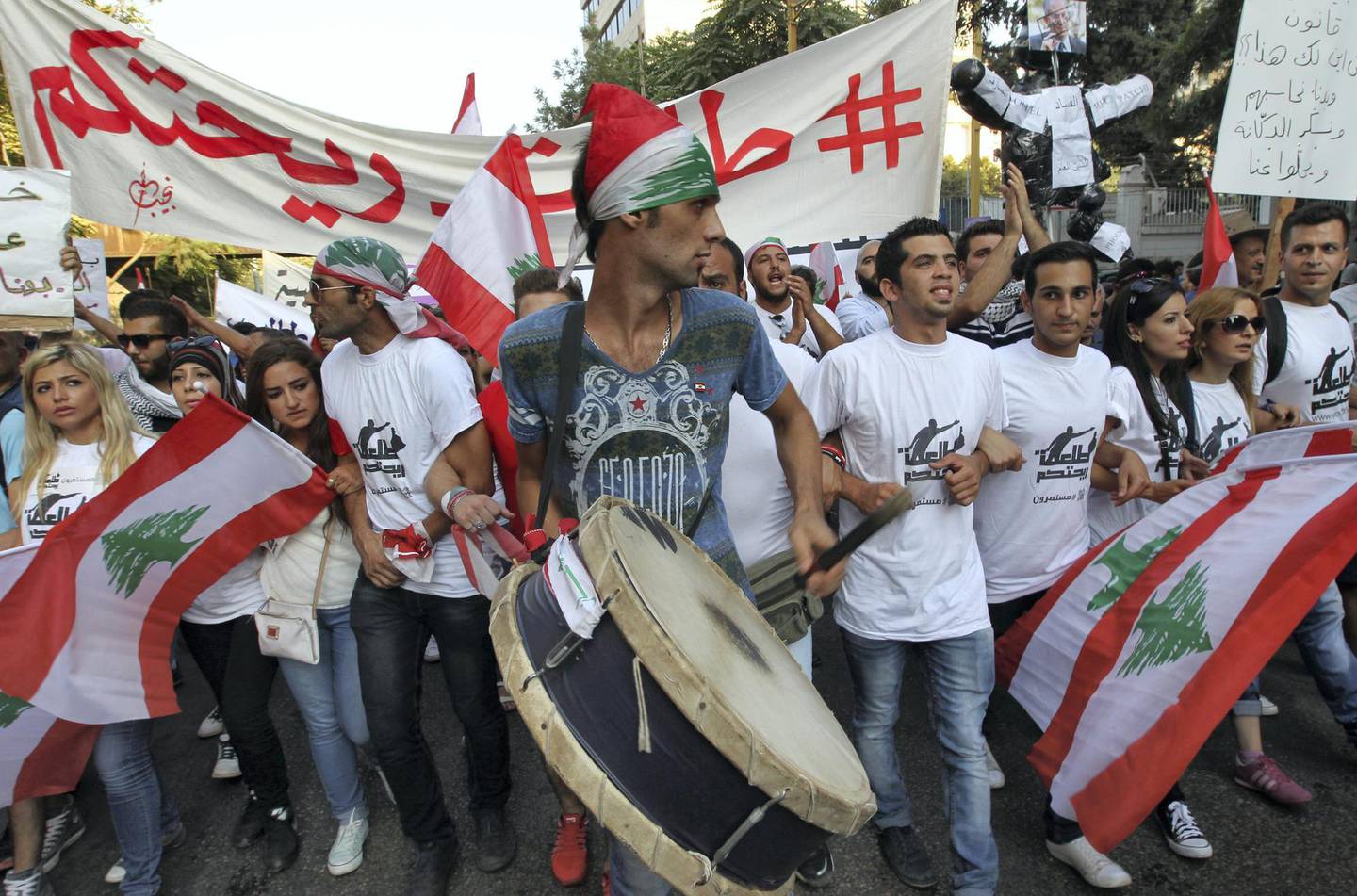 Lebanese protesters wave national flags during a demonstration denouncing Lebanon's stagnant political system, that has become the target of demonstrations following a trash crisis, on September 20, 2015, in the capital Beirut. AFP PHOTO / ANWAR AMRO (Photo by ANWAR AMRO / AFP)