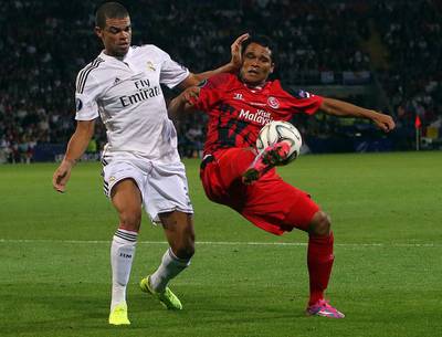 Pepe (L) of Real Madrid and Carlos Bacca (R) of Sevilla vie for the ball during the UEFA Super Cup match between Real Madrid CF and Sevilla FC at the Cardiff City Stadium, Cardiff, Britain, 12 August 2014.  EPA/GEOFF CADDICK
