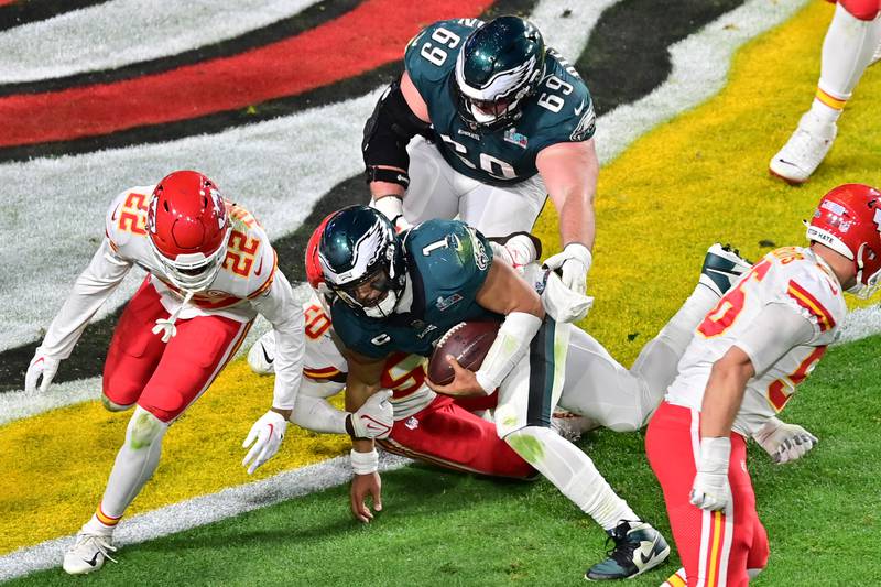 Philadelphia Eagles quarterback Jalen Hurts (1) runs the ball on a successful two point conversion against Kansas City Chiefs safety Juan Thornhill (22) and linebacker Willie Gay (50) and defensive end George Karlaftis (56) during the fourth quarter of Super Bowl LVII. Reuters