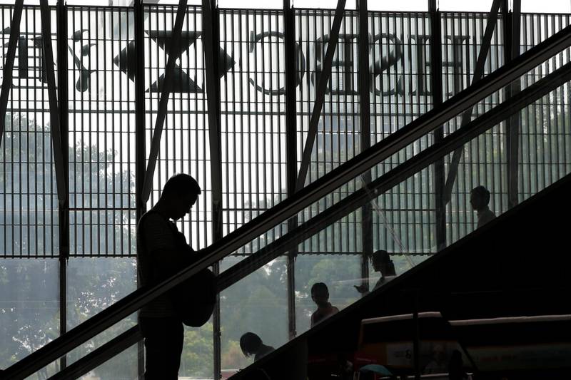 A man takes an escalator at the HSBC building in Hong Kong, Monday, July 31, 2017. HSBC is reporting that pretax profit rose 12 percent in the first half as revenue expanded faster than costs and higher interest rates fattened margins for its Hong Kong lending business. (AP Photo/Kin Cheung)