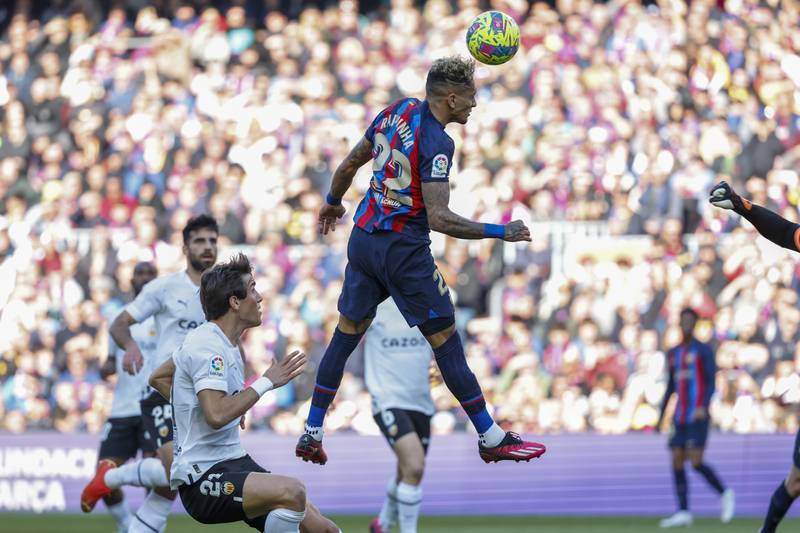 Barcelona's Raphinha scores his side's opening goal during Spanish La Liga soccer match between Barcelona and Valencia at the Camp Nou stadium in Barcelona, Spain, Sunday, March 5, 2023.  (AP Photo / Joan Monfort)