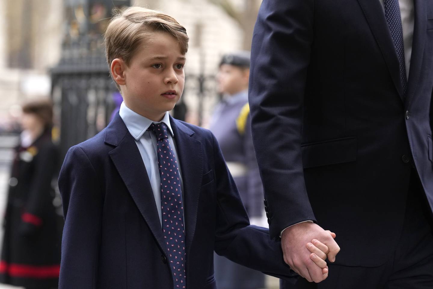 Prince George holds the hand of his father Prince William as they arrive to attend a service of thanksgiving for the life of Prince Philip, Duke of Edinburgh. AP 
