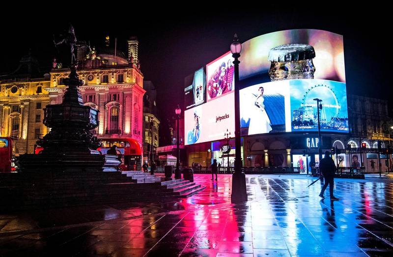 A man walks across the normally busy Piccadilly Circus in central London. AP Photo