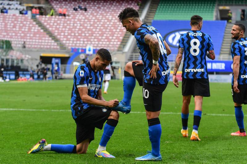 Inter's Lautaro Martinez enjoys a shoe shine from Achraf Hakimi after scoring. AFP