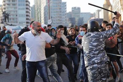 Riot police swing batons at anti-government protesters during clashes during a protest in downtown Beirut. AP Photo