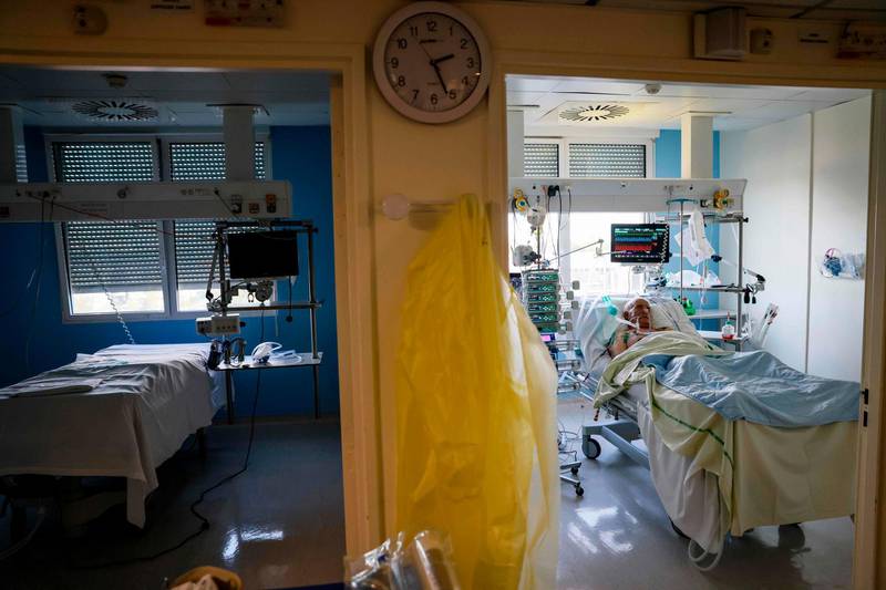A patient infected with coronavirus lies in an intensive care room of the Estree Private Hospital in Stains, on the outskirts of Paris on November 12, 2020.  AFP