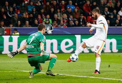 Daniele De Rossi of AS Roma shoots past goalkeeper Bernd Leno of Bayer Levekusen to score their first goal in the Champions League match on Tuesday. Dean Mouhtaropoulos / Bongarts / Getty Images