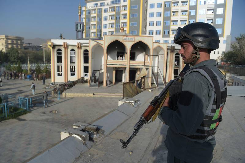 An Afghan policeman keeps watch a day after a suicide attack on a Shiite mosque in Kabul on August 26, 2017. Shah Marai / AFP